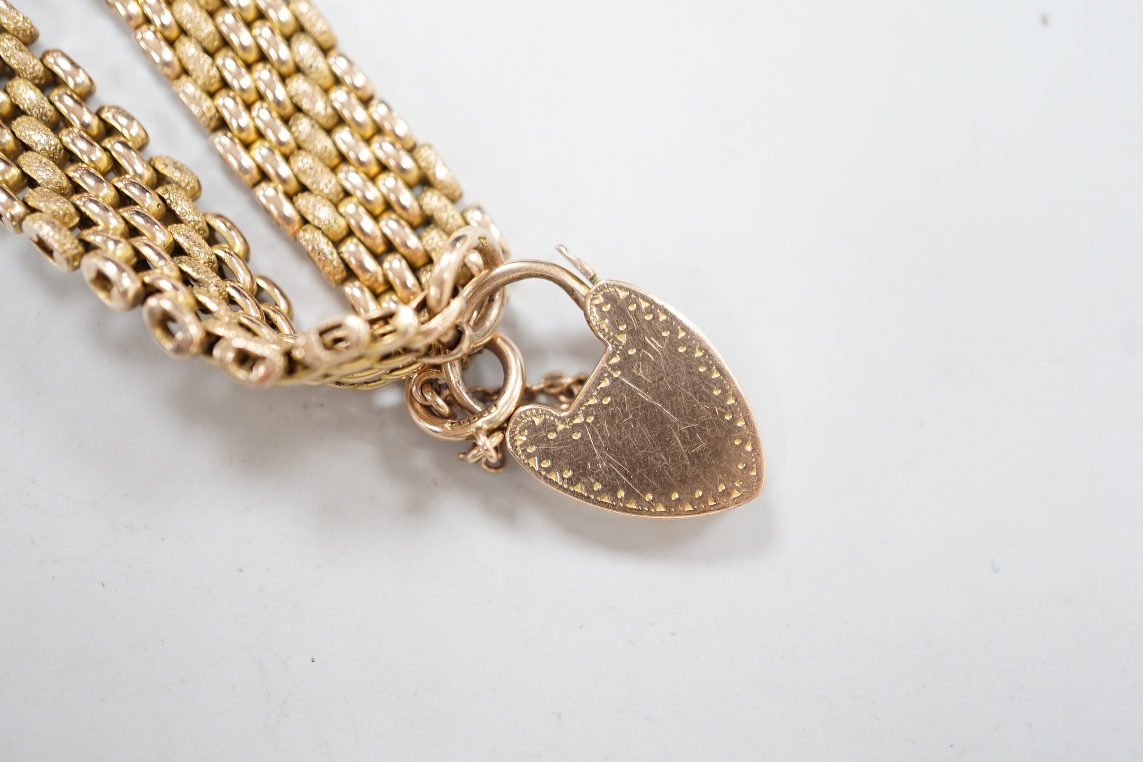 An early 20th century yellow metal (stamped 9c) gate link bracelet, with heart shaped padlock clasp, 18cm, 24.7 grams.